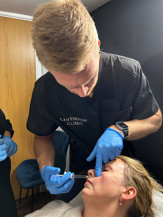 A doctor practicing using anti-wrinkle treatments