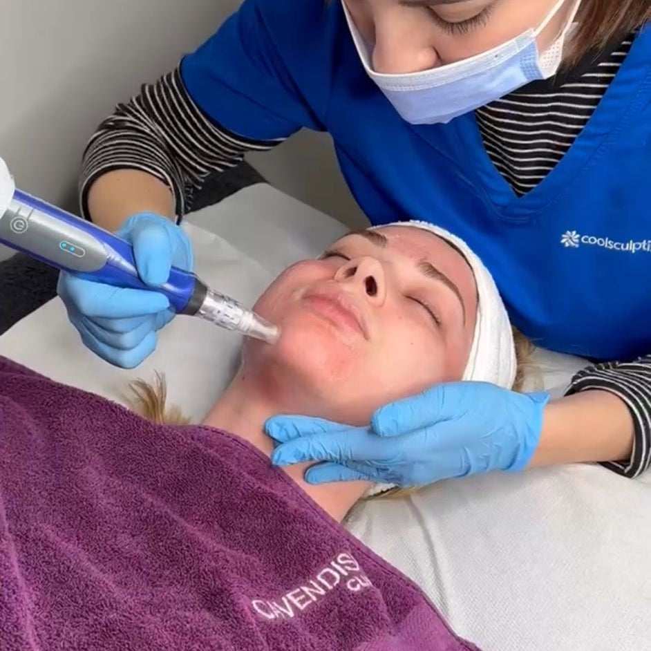 Person receiving a facial treatment with a professional in a clinical setting.